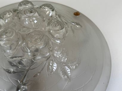Circular frosted glass bowl with roses in...