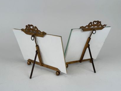 Two beveled glass and brass picture frames...