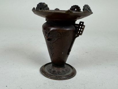 ASIA, 20th C. Small patinated bronze candlestick...