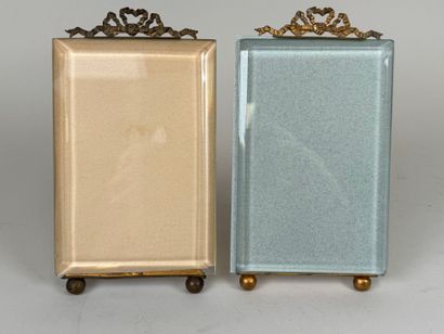 Two beveled glass and brass picture frames...