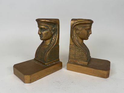 A pair of bookends in wood and gilded stucco,...