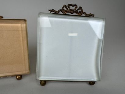 Two beveled glass and brass picture frames...