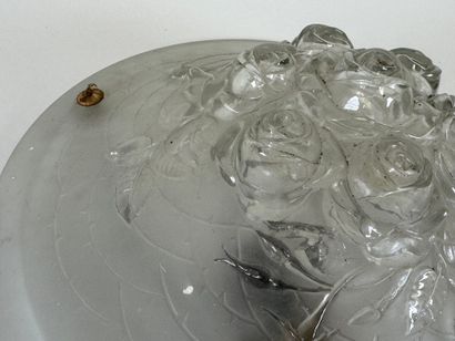 Circular frosted glass bowl with roses in...