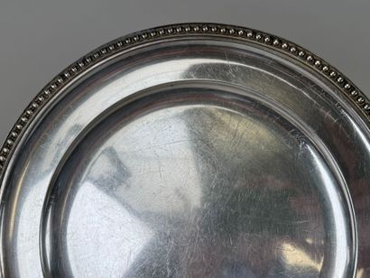 Circular dish decorated with a string of...