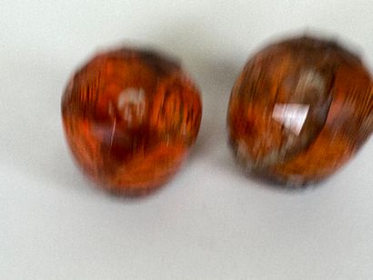 Two faceted and colored glass paperweight...