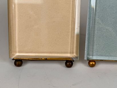 Two beveled glass and brass picture frames...