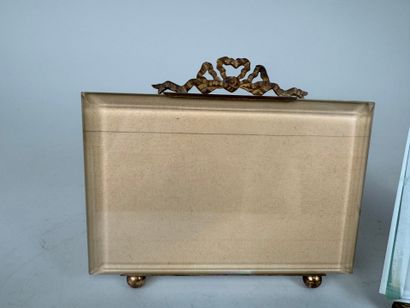 Two beveled glass and brass picture frames...