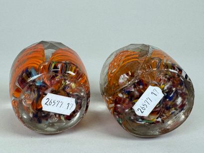 Two faceted and colored glass paperweight...