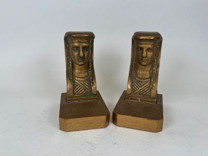 A pair of bookends in wood and gilded stucco,...