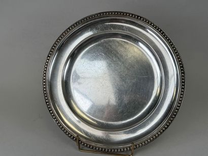 Circular dish decorated with a string of...