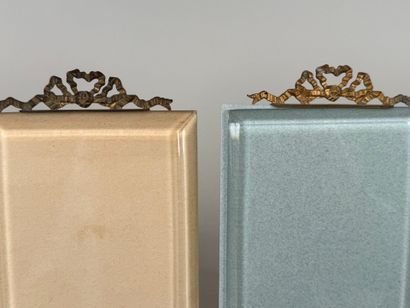 Two beveled glass and brass picture frames...