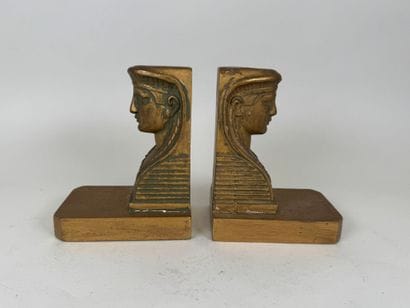 A pair of bookends in wood and gilded stucco,...