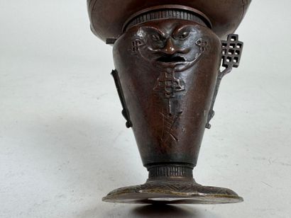 ASIA, 20th C. Small patinated bronze candlestick...