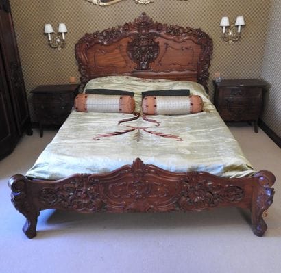 Carved wood bed with openwork decoration....