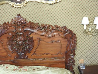 Carved wood bed with openwork decoration....