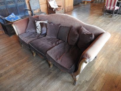 Carved oak three-seater sofa on eight legs....