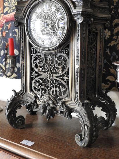 Partially openwork bronze clock, the enameled...