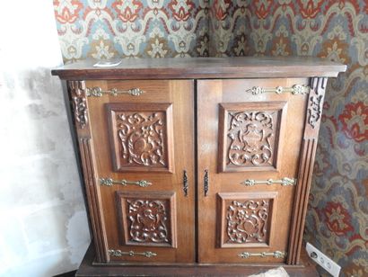 Small bookcase opening with two doors and...