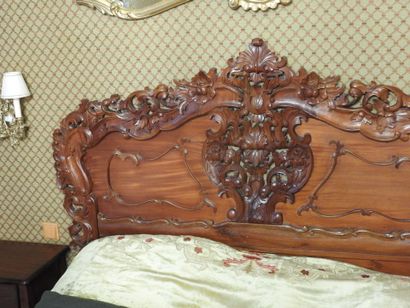 Carved wood bed with openwork decoration....