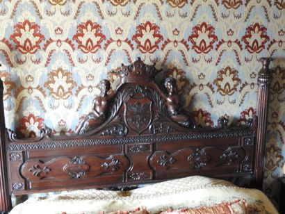 Large carved wood bed decorated with women...