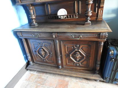 Carved wood sideboard with three doors on...