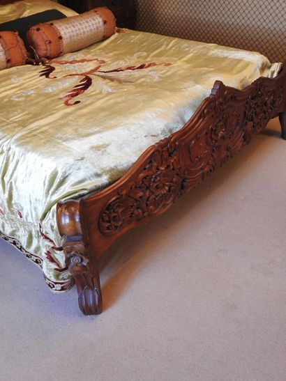 Carved wood bed with openwork decoration....