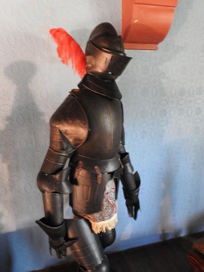 Black patinated and riveted metal armor....