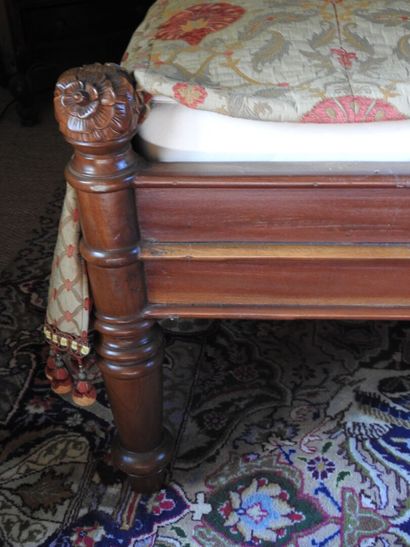 Large carved wood bed with figures and foliage.
181...