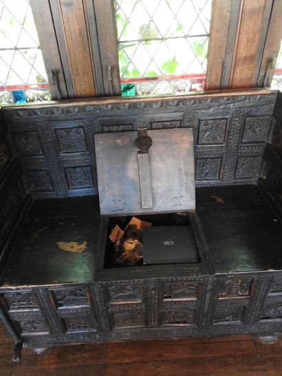 Church bench forming a chest in wood carved...