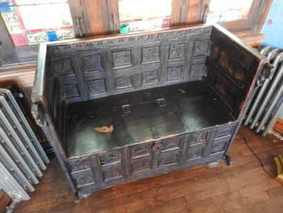 Church bench forming a chest in wood carved...