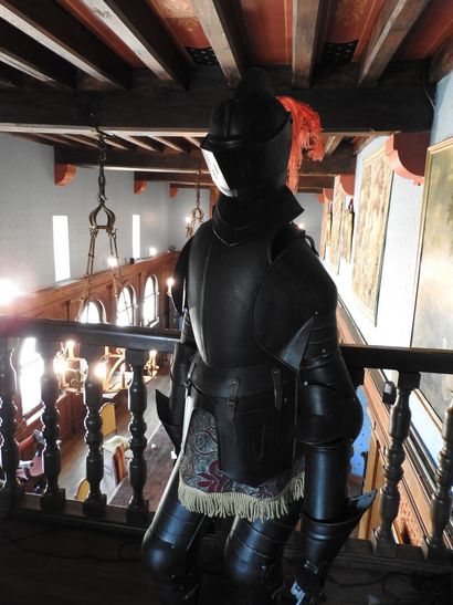 Black patinated and riveted metal armor....