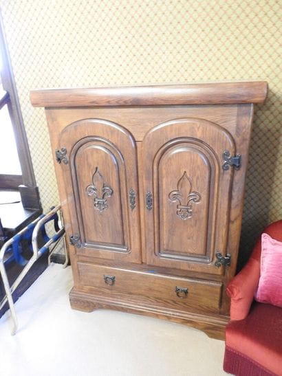 Rustic oak cabinet with two doors decorated...