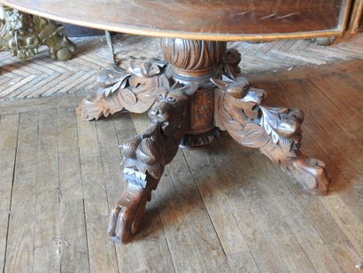 Carved oak oval middle table resting on four...
