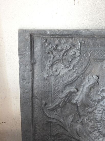 Cast iron fireback decorated with the coat...