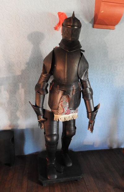 Black patinated and riveted metal armor....