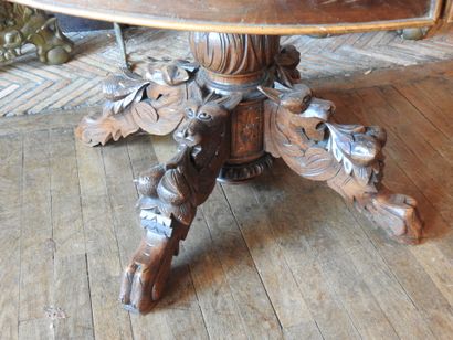 Carved oak oval middle table resting on four...