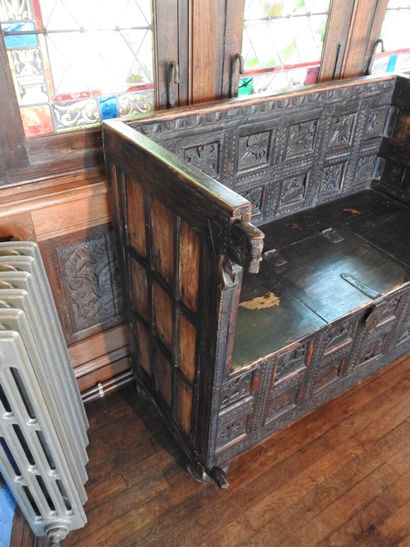 Church bench forming a chest in wood carved...