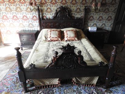 Large carved wood bed decorated with women...
