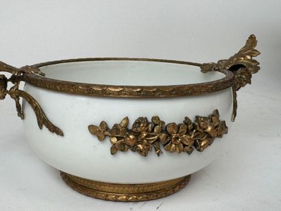 A small white porcelain bowl, with two chased...