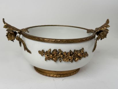 A small white porcelain bowl, with two chased...