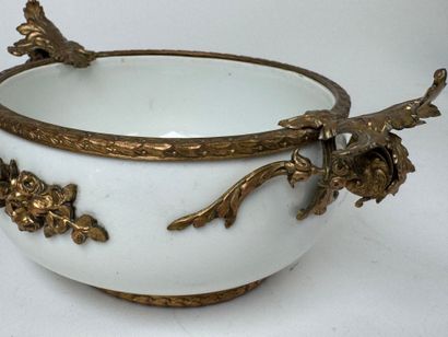 A small white porcelain bowl, with two chased...