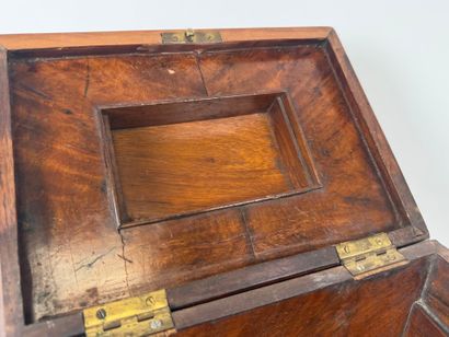 Wood and veneer chest in the shape of a sarcophagus.
Restoration...