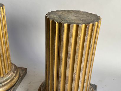 Pair of patinated and gilded oak sellettes...