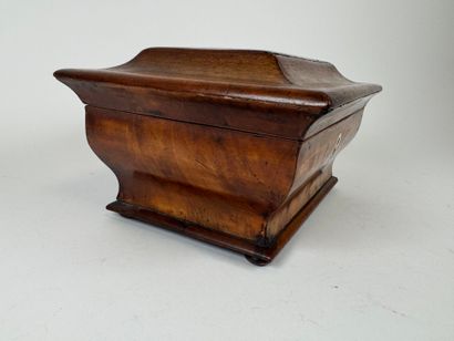 Wood and veneer chest in the shape of a sarcophagus.
Restoration...