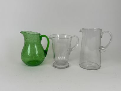 Three glass pitchers, one bubbled colored...