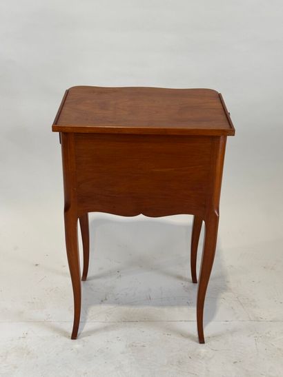 Moulded wood bedside table opening with three...