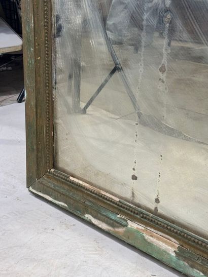 Large mirror in wood and gilded stucco decorated...