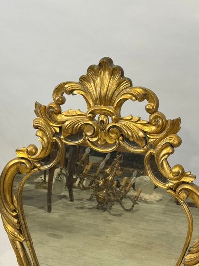 Gilded wood glazed mirror with a violin shape,...