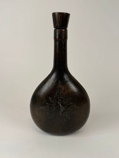 Leather-wrapped flask with small iron motif.
H....