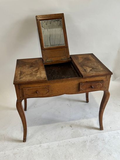 Moulded walnut dressing table, the top opening...